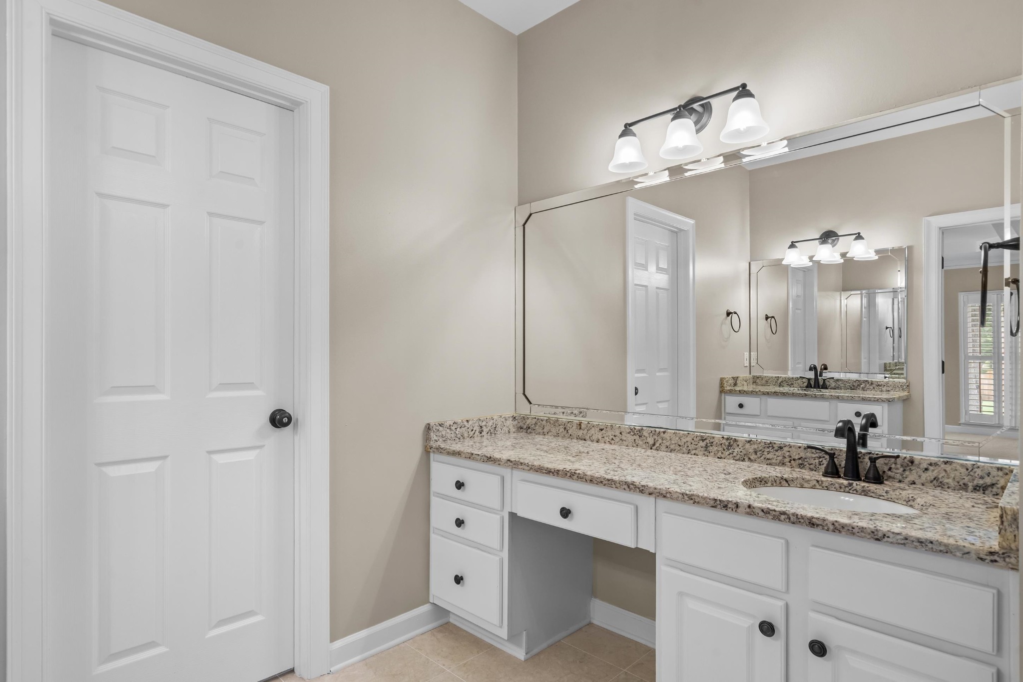 927 Oakmont Ridge Cove Collierville, TN 38017 - Photo 19 of 40 a bathroom with a granite countertop sink a mirror and a shower