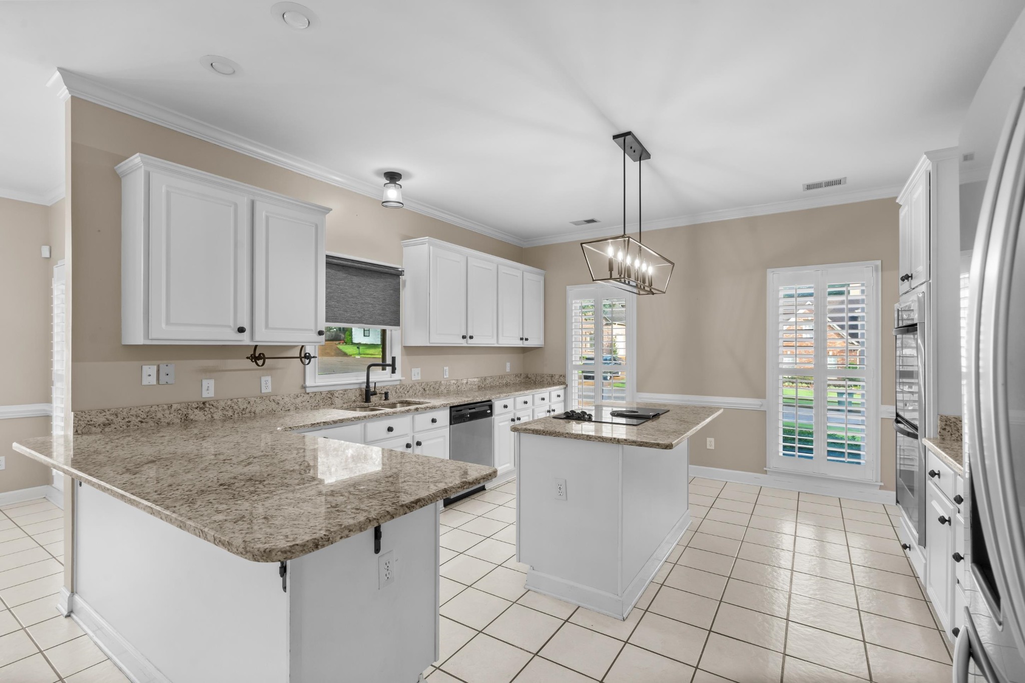 927 Oakmont Ridge Cove Collierville, TN 38017 - Photo 3 of 40 a kitchen with stainless steel appliances granite countertop a sink stove and refrigerator