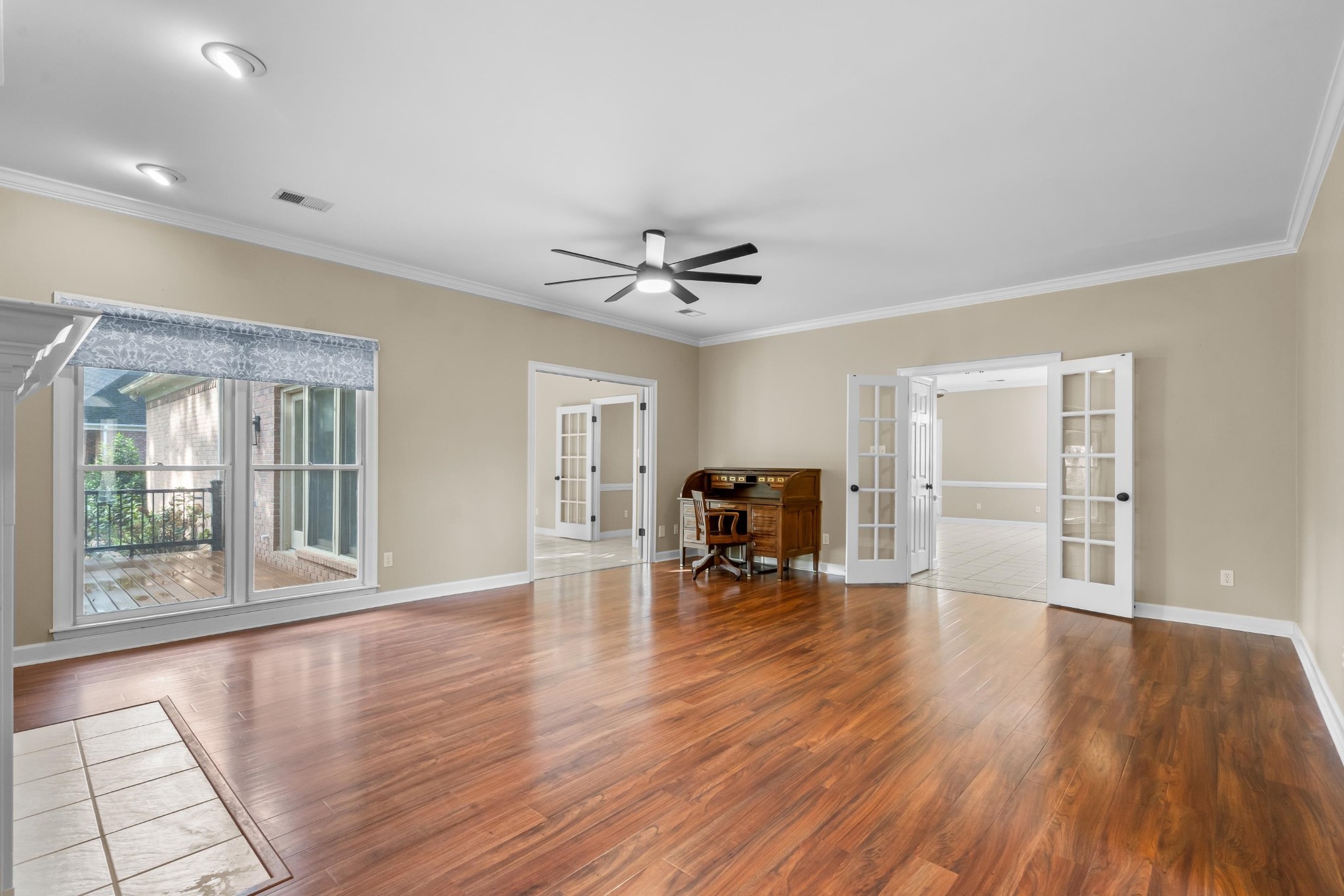 927 Oakmont Ridge Cove Collierville, TN 38017 - Photo 8 of 40 a view of a livingroom with a hardwood floor and a ceiling fan
