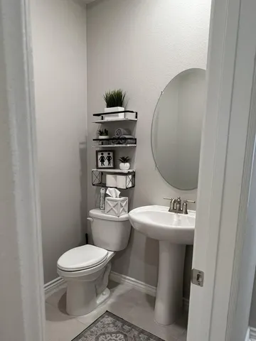 a view of a hallway with wooden floor and a cabinet