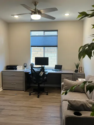 a living room with furniture and a floor to ceiling window