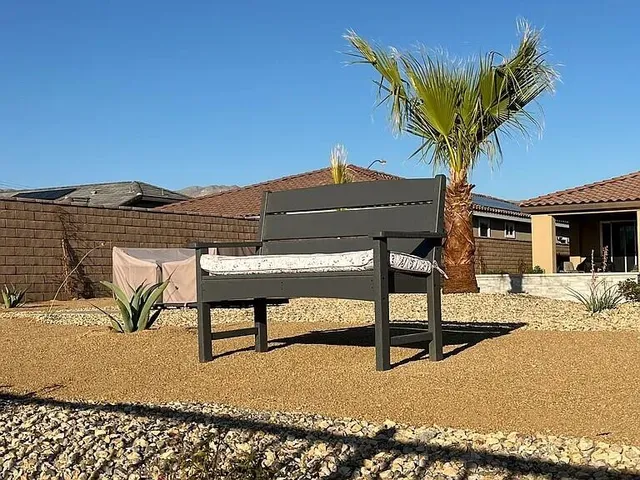 a view of a patio with table and chairs with wooden floor and fence