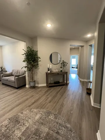 a living room with furniture and a wooden floor