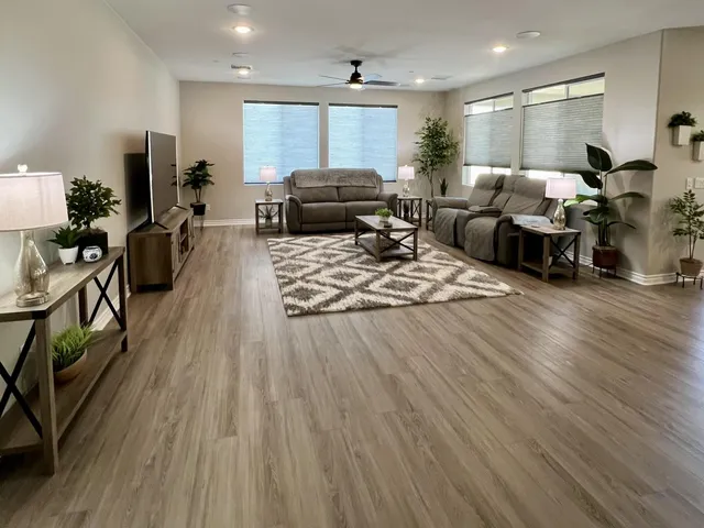 a living room with furniture and wooden floor