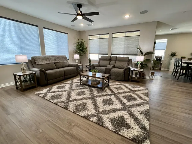 a living room with furniture and wooden floor