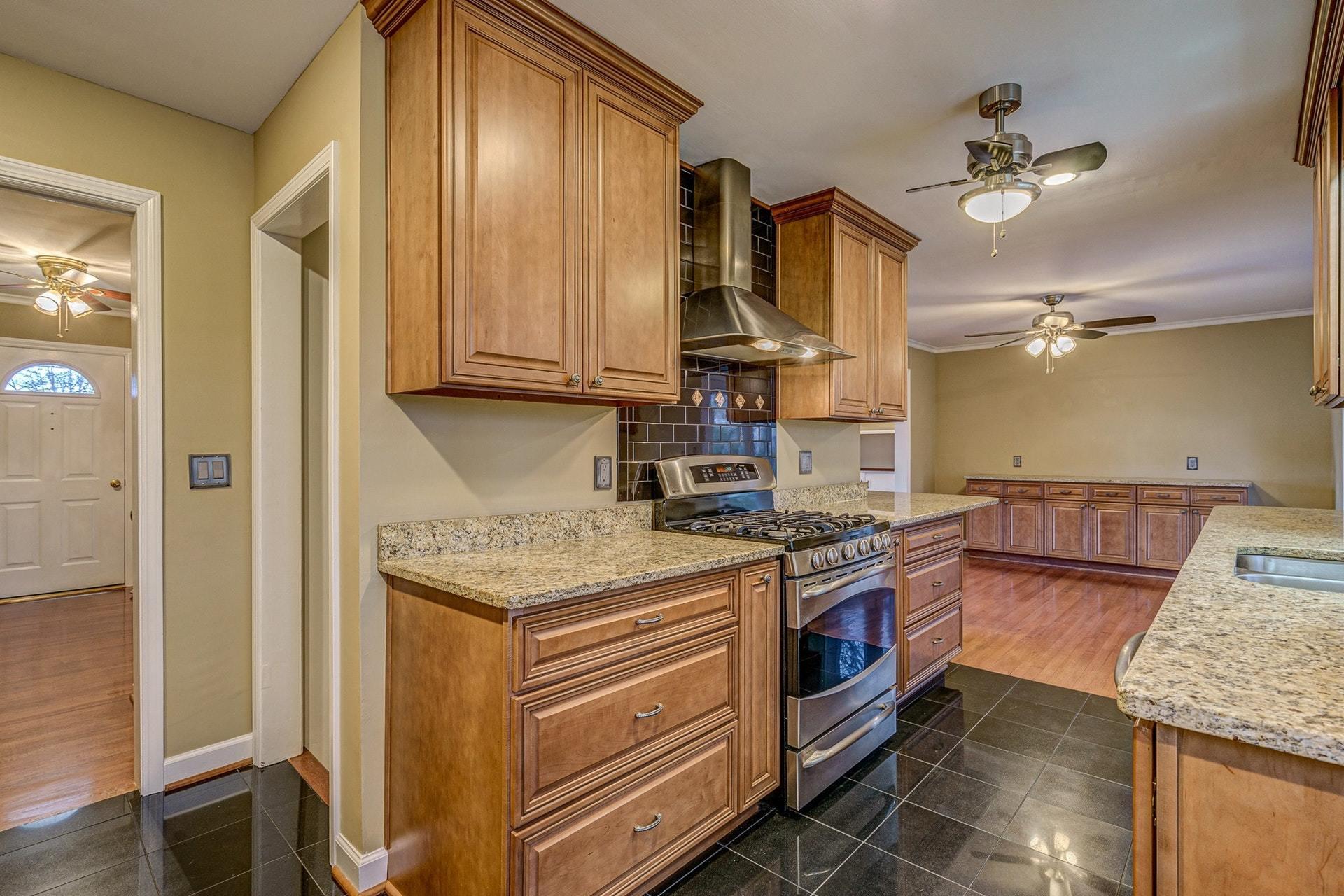 3586 Forester Road Southwest Roanoke, VA 24018 - Photo 16 of 51 a kitchen with stainless steel appliances granite countertop a stove a sink and a refrigerator