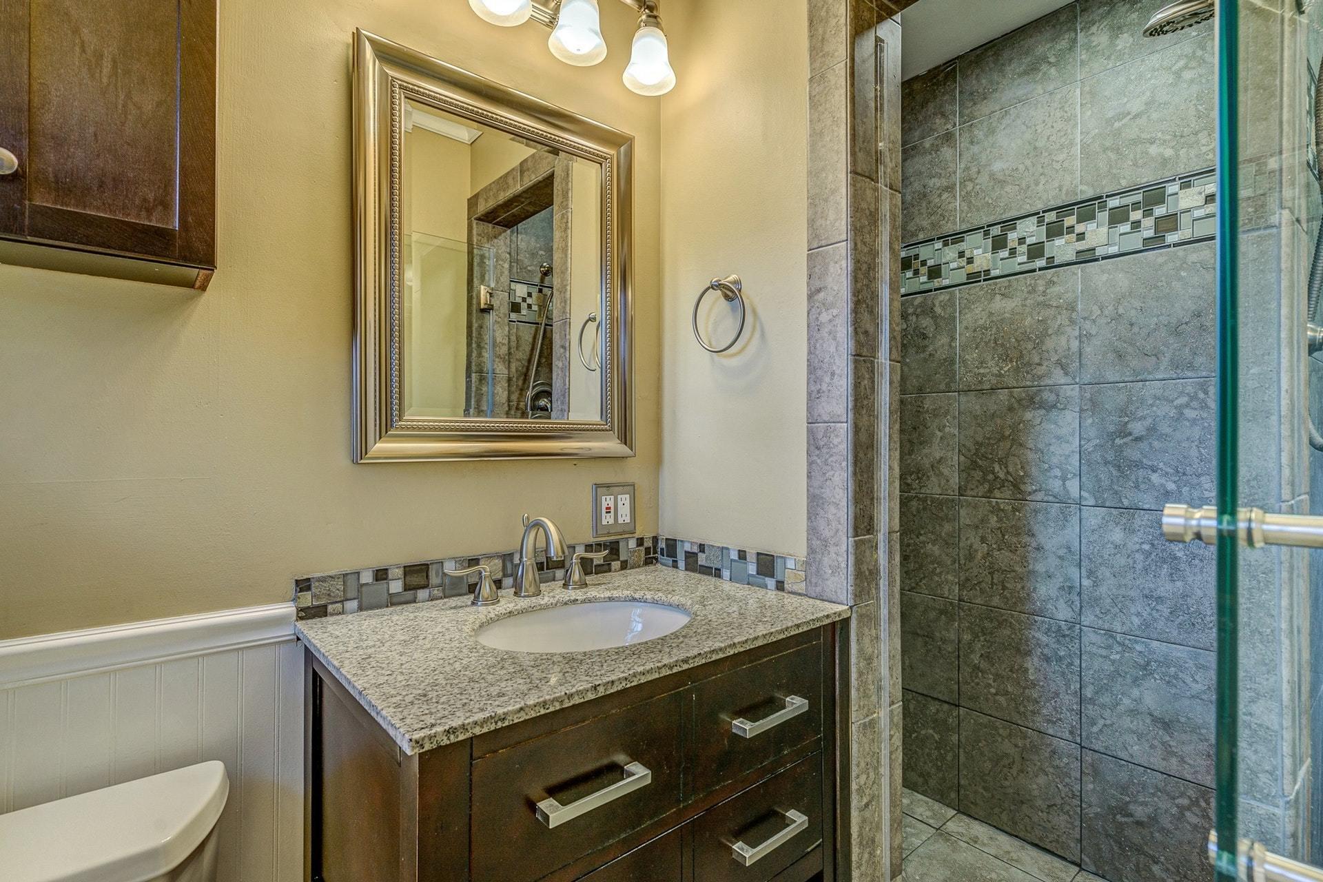 3586 Forester Road Southwest Roanoke, VA 24018 - Photo 20 of 51 a bathroom with a granite countertop sink a toilet and shower