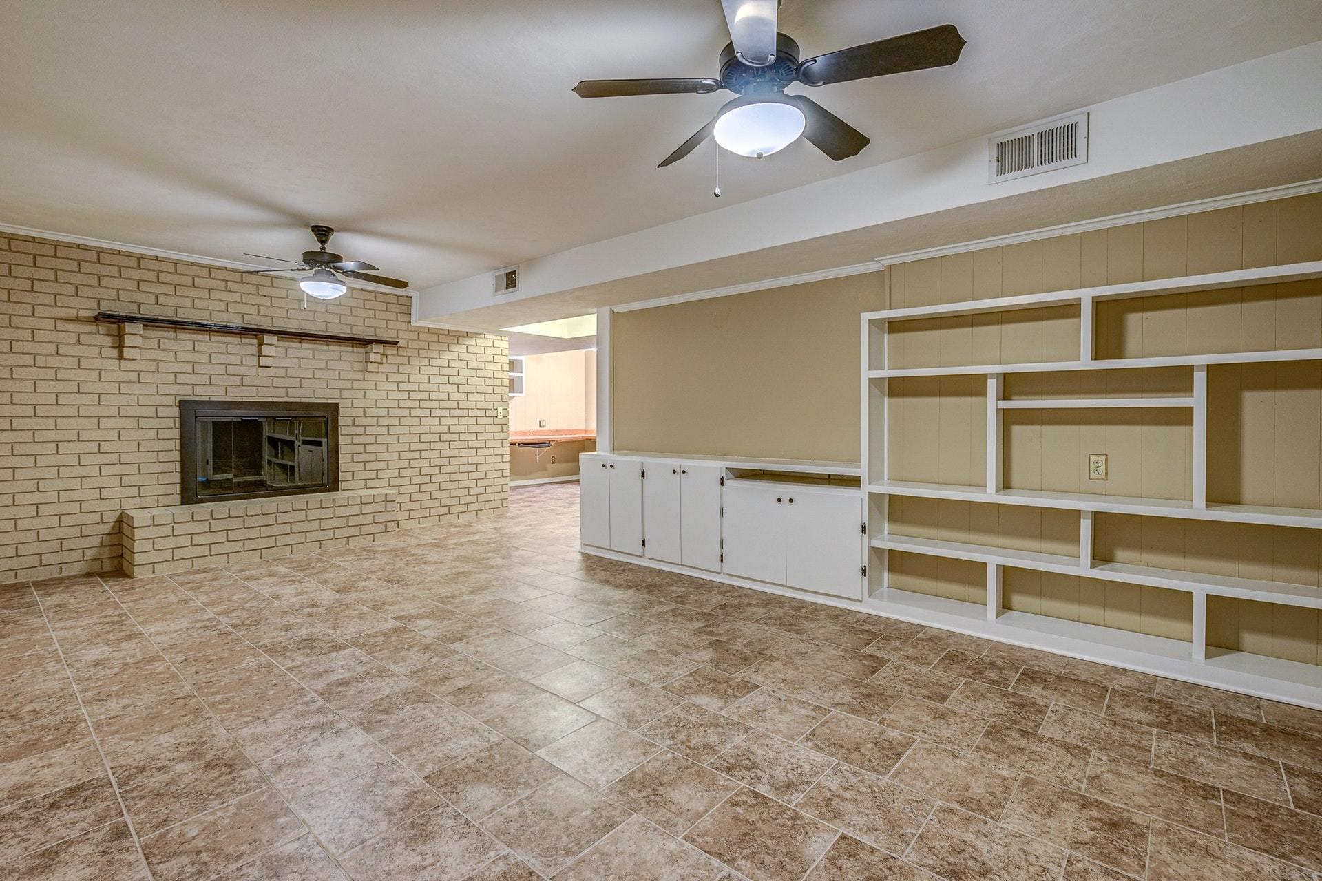 3586 Forester Road Southwest Roanoke, VA 24018 - Photo 30 of 51 a view of an empty room with a fireplace and a ceiling fan