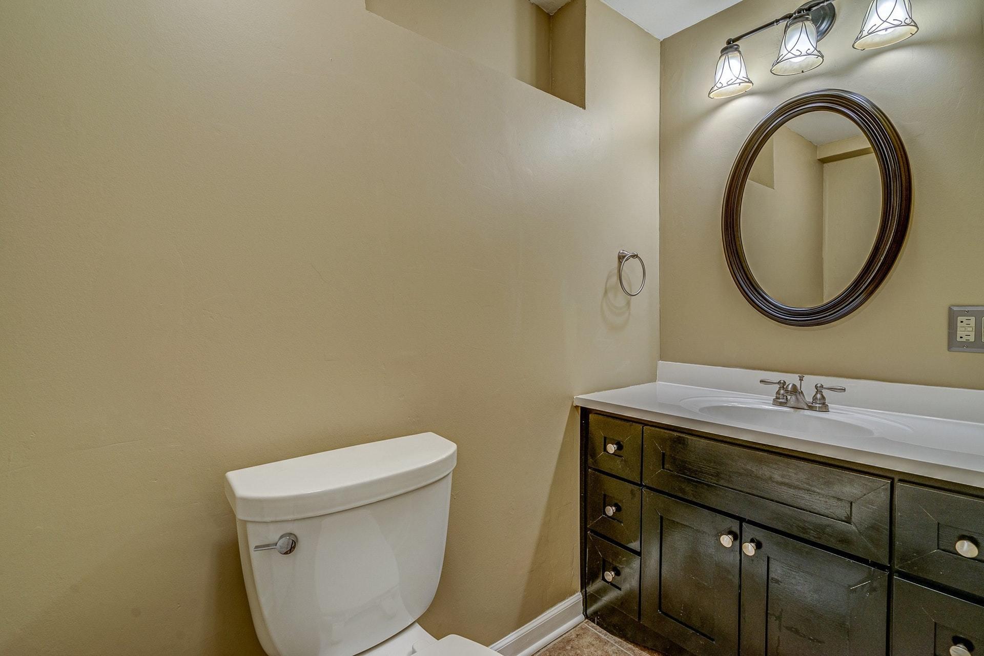 3586 Forester Road Southwest Roanoke, VA 24018 - Photo 32 of 51 a bathroom with a granite countertop toilet sink and mirror