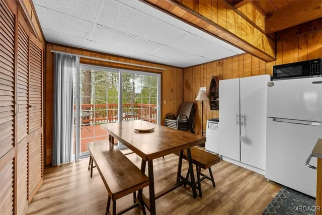 a kitchen with a table chairs refrigerator and cabinets