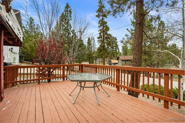 a view of balcony with wooden floor and fence