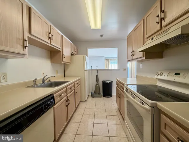 a kitchen with stainless steel appliances granite countertop a sink and a stove