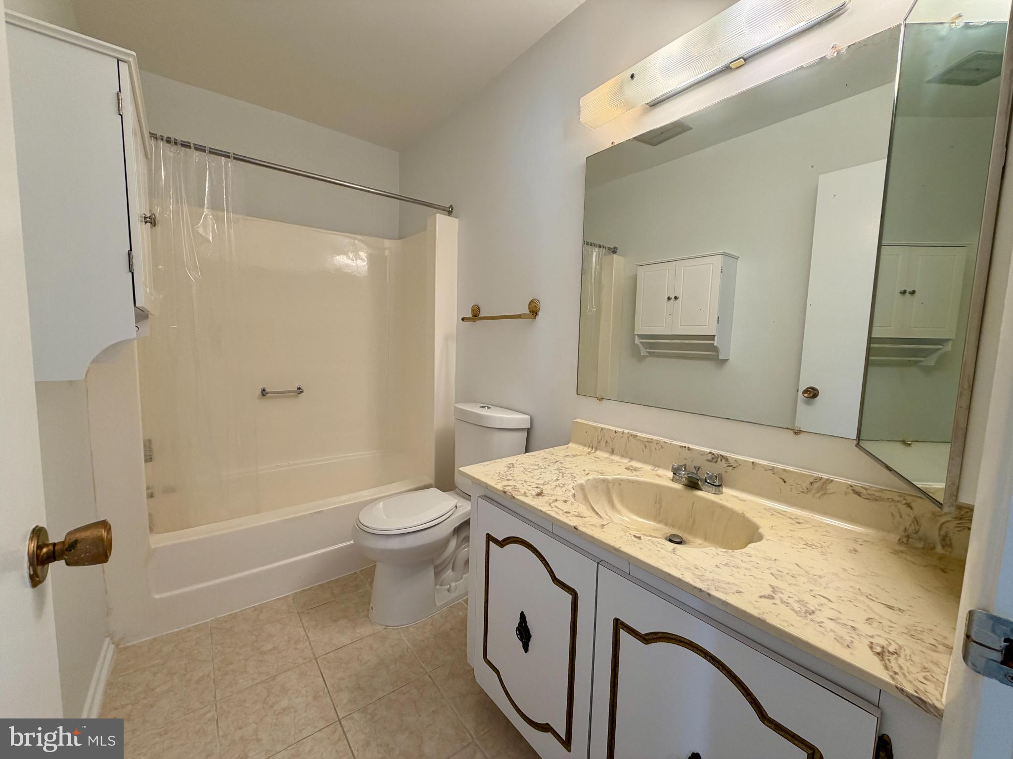 3103 Beckenham Court, Unit 252D Silver Spring, MD 20906 - Photo 7 of 13 a bathroom with a sink a toilet and shower