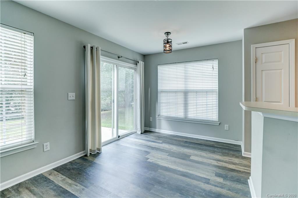 7243 Cascading Pines Drive Tega Cay, SC 29708 - Photo 12 of 33 an empty room with wooden floor and windows