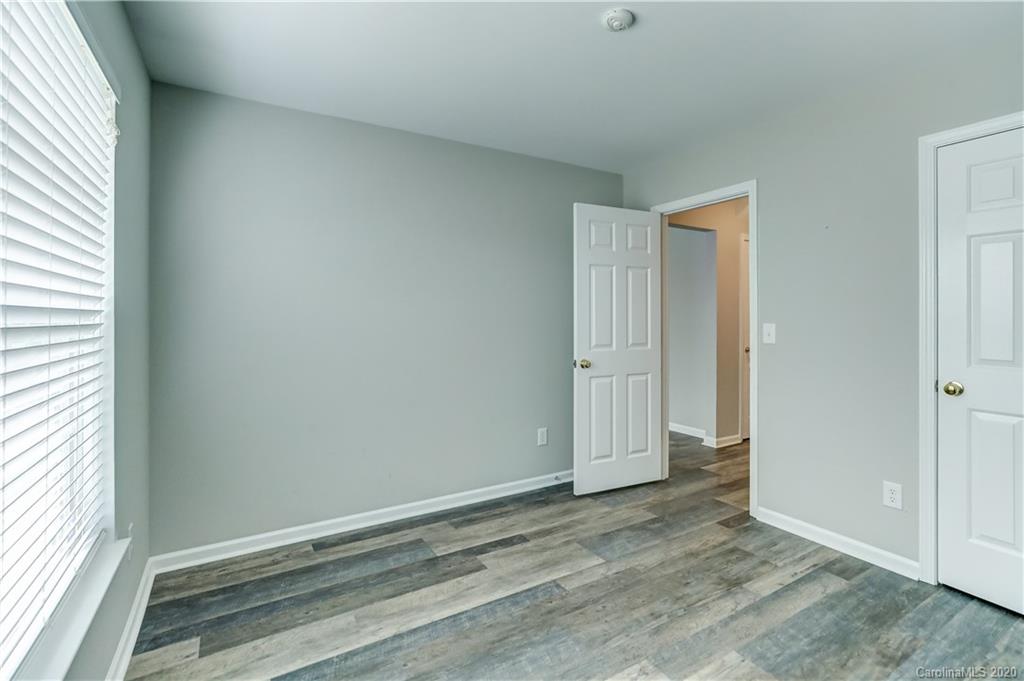 7243 Cascading Pines Drive Tega Cay, SC 29708 - Photo 14 of 33 an empty room with wooden floor and windows
