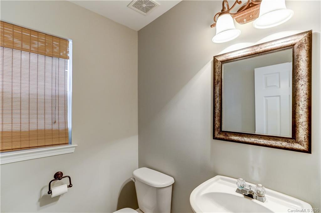 7243 Cascading Pines Drive Tega Cay, SC 29708 - Photo 15 of 33 a bathroom with a toilet sink and mirror