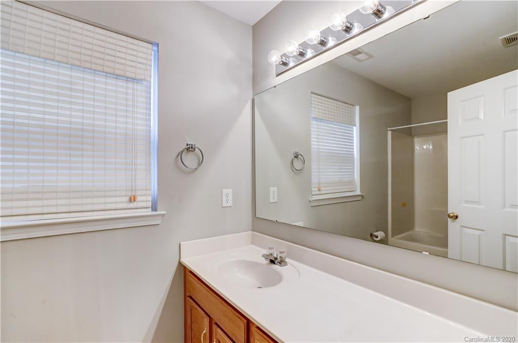 7243 Cascading Pines Drive Tega Cay, SC 29708 - Photo 16 of 33 a bathroom with a sink and a mirror