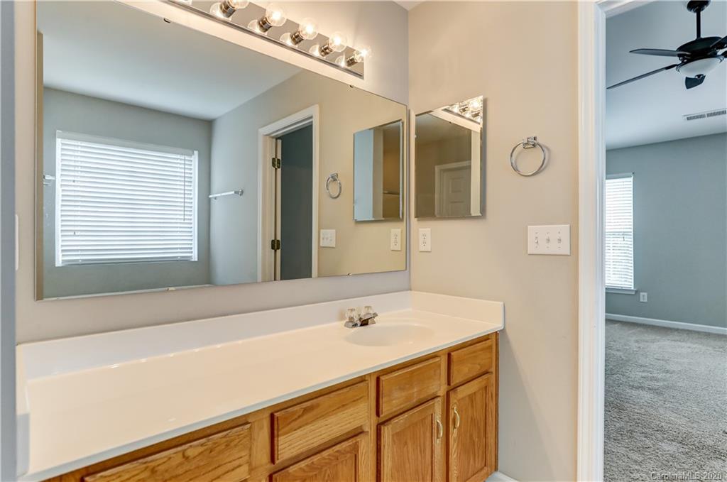 7243 Cascading Pines Drive Tega Cay, SC 29708 - Photo 23 of 33 a bathroom with a sink and a mirror