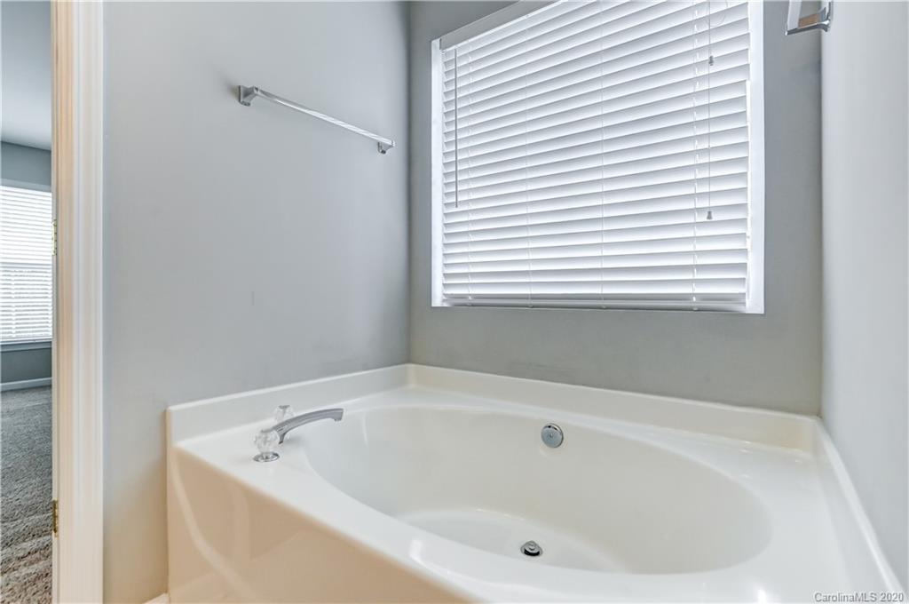 7243 Cascading Pines Drive Tega Cay, SC 29708 - Photo 24 of 33 a white bath tub sitting in a bathroom