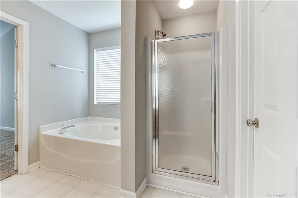 7243 Cascading Pines Drive Tega Cay, SC 29708 - Photo 25 of 33 a bathroom with a bathtub and shower