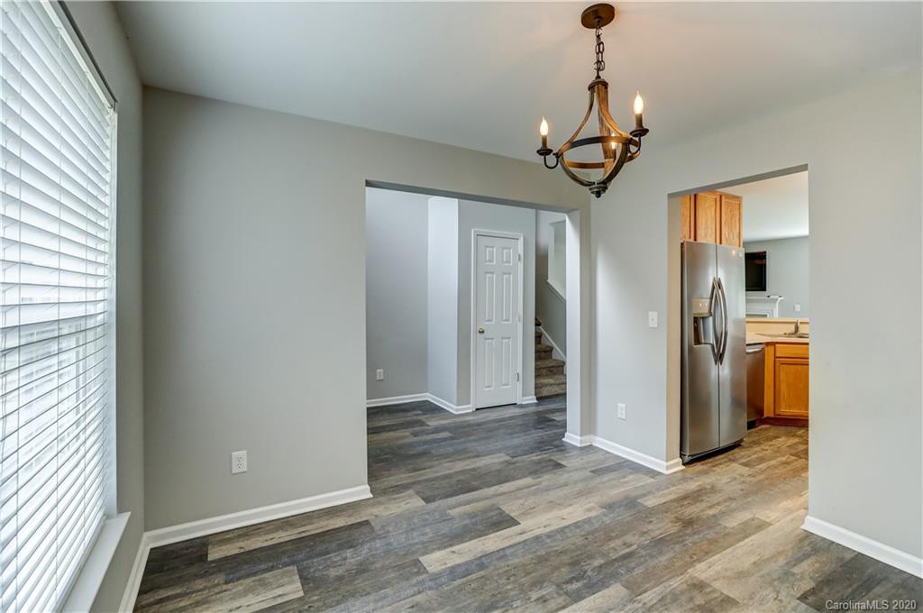 7243 Cascading Pines Drive Tega Cay, SC 29708 - Photo 5 of 33 a view of a hallway with wooden floor and staircase