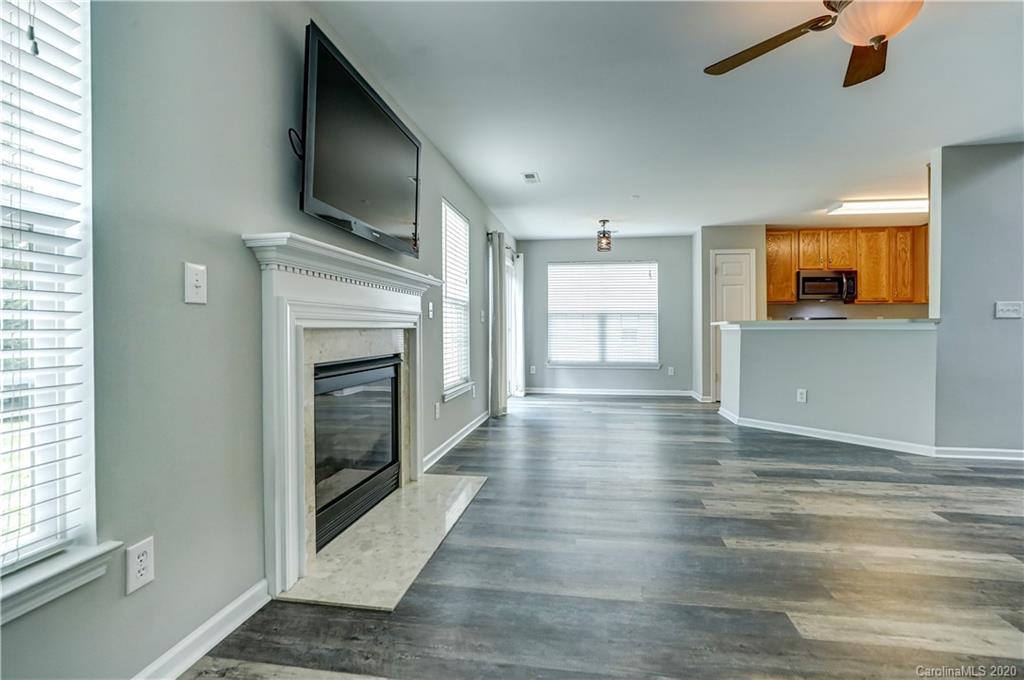 7243 Cascading Pines Drive Tega Cay, SC 29708 - Photo 6 of 33 a view of a livingroom with an empty space and a fireplace