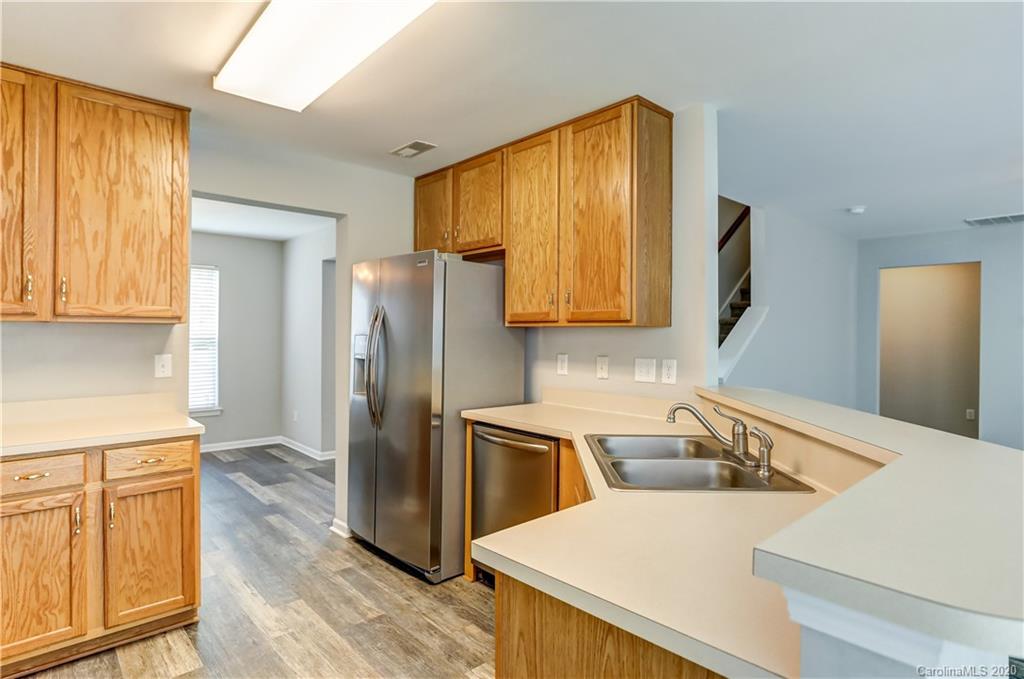 7243 Cascading Pines Drive Tega Cay, SC 29708 - Photo 8 of 33 a kitchen with a refrigerator sink and cabinets