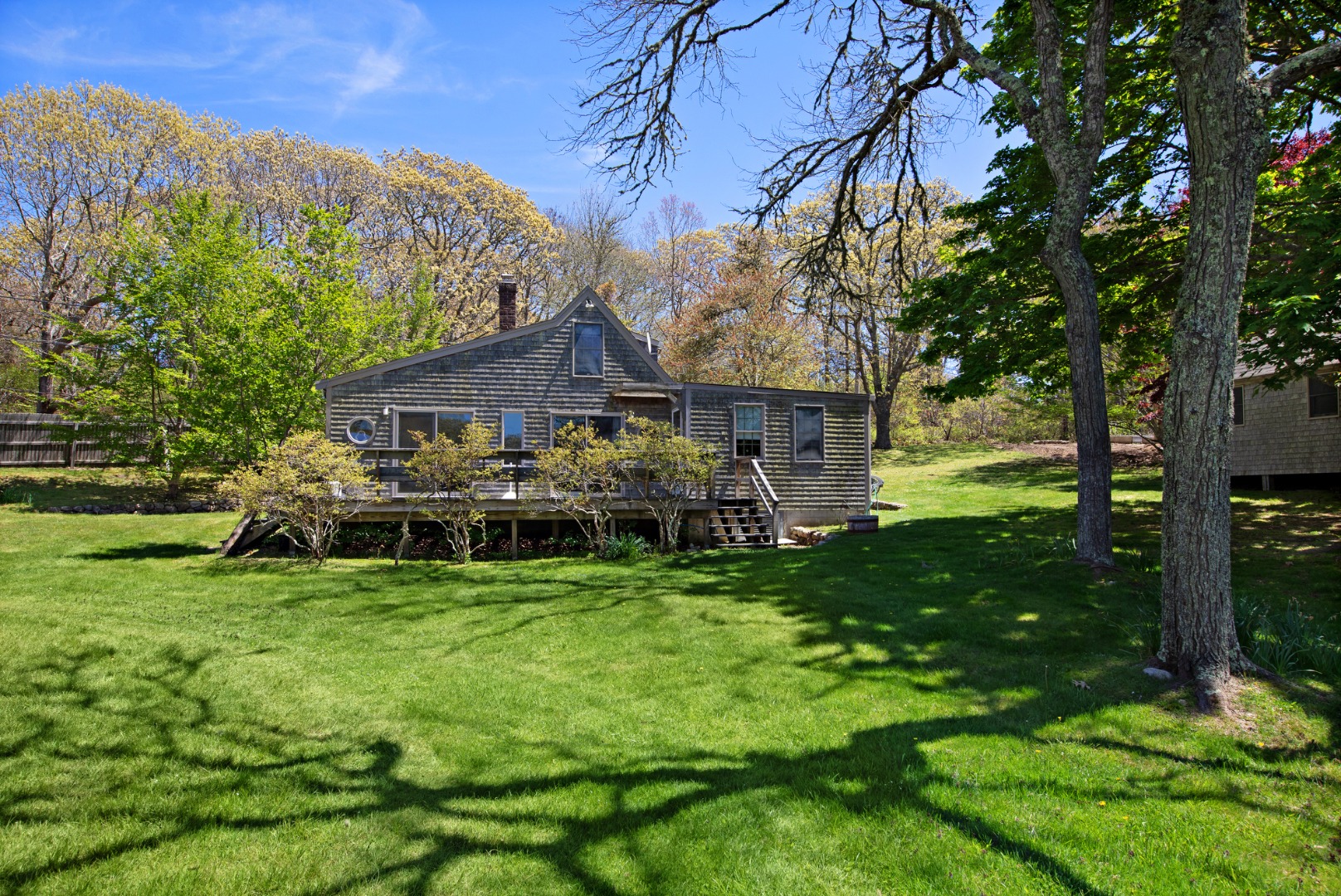 a view of a house with a yard deck and sitting area