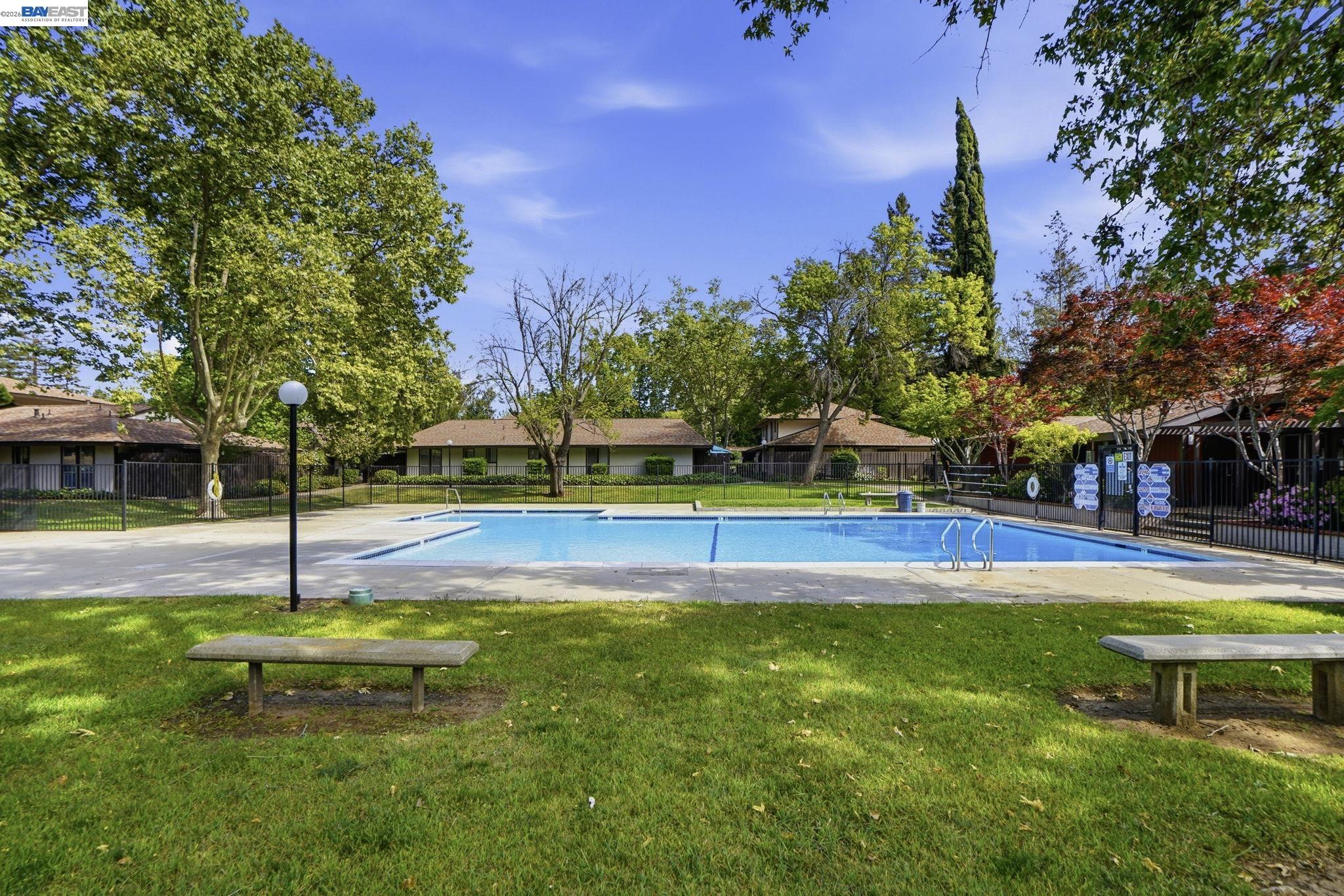 5505 Roundtree Drive, Unit B Concord, CA 94521 - Photo 29 of 29 a swimming pool with lots of tress in front of it