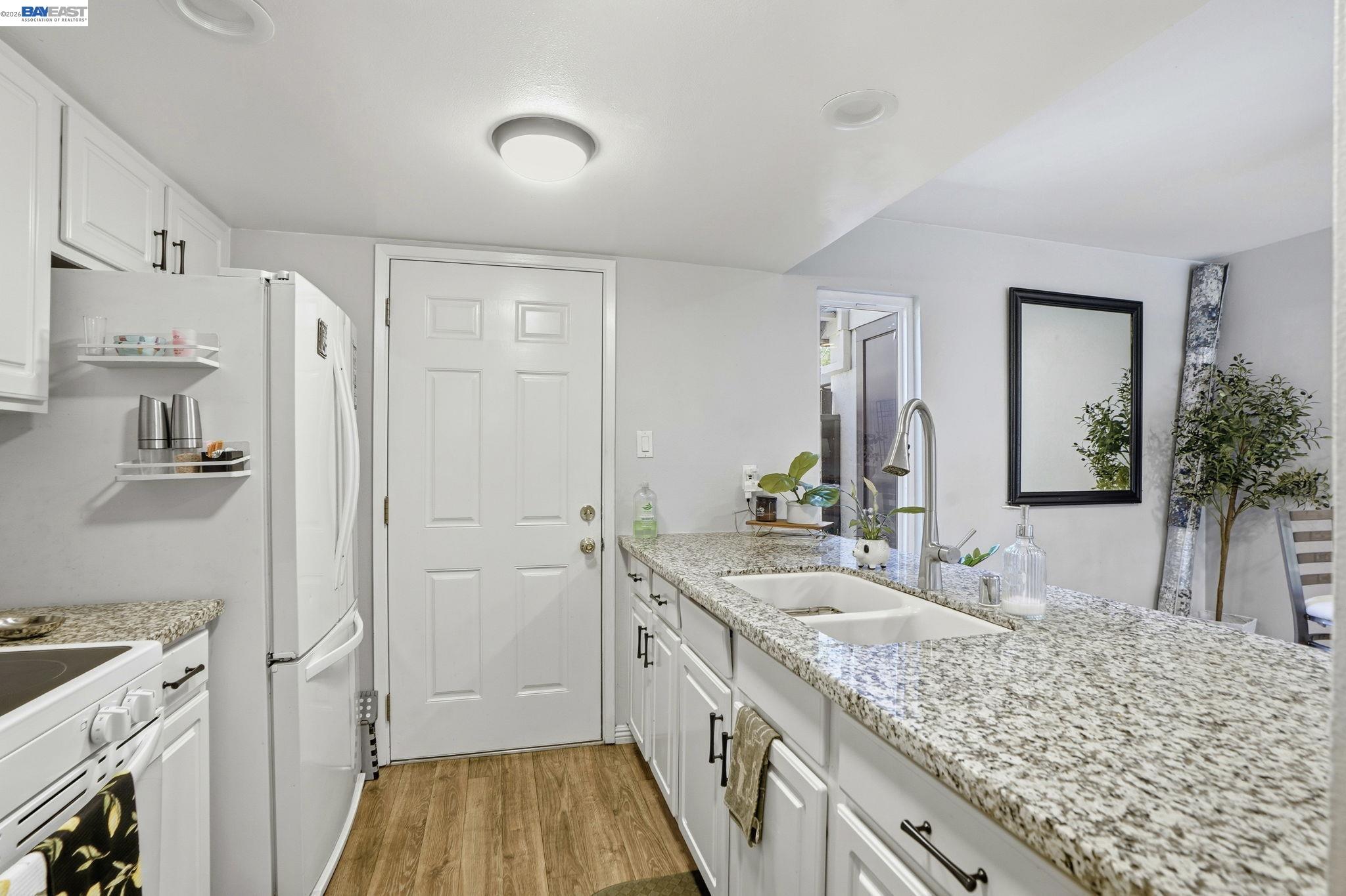 5505 Roundtree Drive, Unit B Concord, CA 94521 - Photo 10 of 29 a bathroom with a granite countertop double vanity sink and mirror