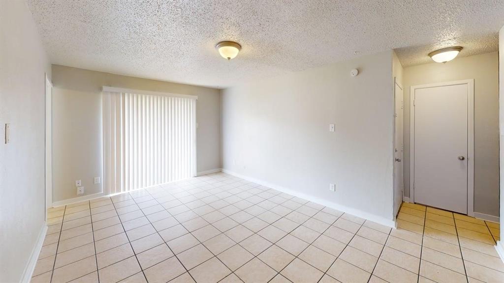 8110 Skillman Street, Unit 1046 Dallas, TX 75231 - Photo 6 of 10 a view of an empty room and window