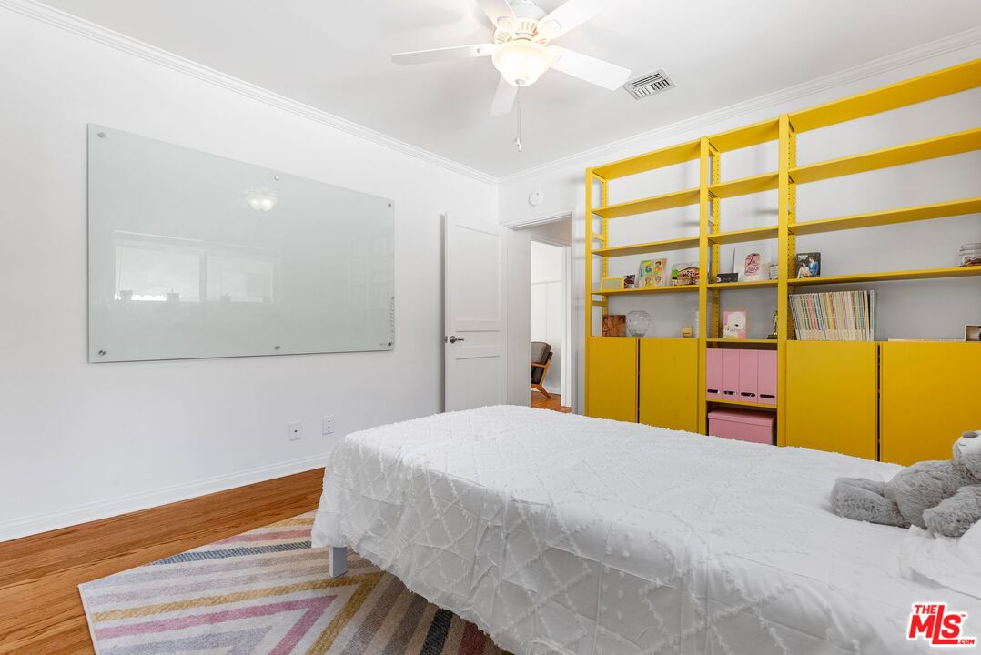 5752 Vesper Avenue Van Nuys, CA 91411 - Photo 11 of 30 a bedroom with a bed and a large window