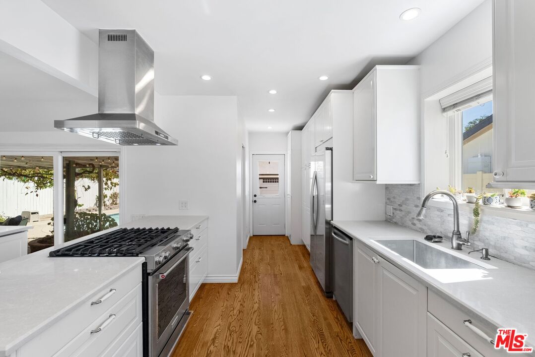 5752 Vesper Avenue Van Nuys, CA 91411 - Photo 15 of 30 a kitchen with stainless steel appliances a sink stove and refrigerator