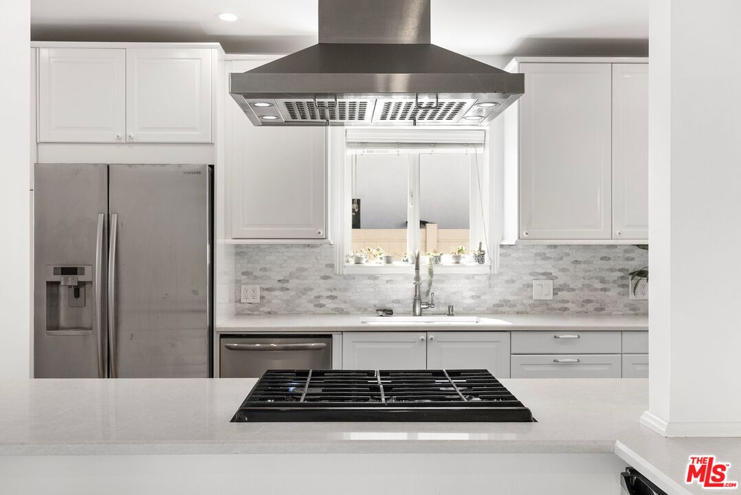 5752 Vesper Avenue Van Nuys, CA 91411 - Photo 2 of 30 a kitchen with stainless steel appliances granite countertop a stove and a refrigerator