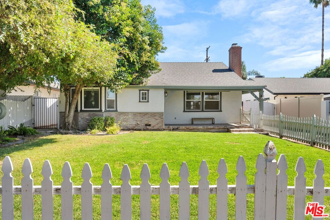 5752 Vesper Avenue Van Nuys, CA 91411 - Photo 28 of 30 a front view of house with yard and trees