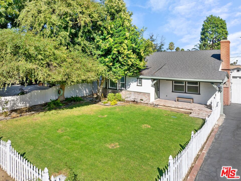 5752 Vesper Avenue Van Nuys, CA 91411 - Photo 29 of 30 a front view of a house with a garden and yard