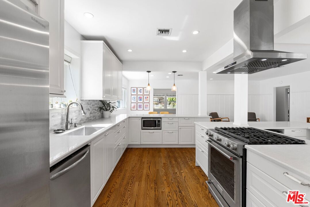 5752 Vesper Avenue Van Nuys, CA 91411 - Photo 3 of 30 a kitchen with stainless steel appliances granite countertop a sink stove and refrigerator