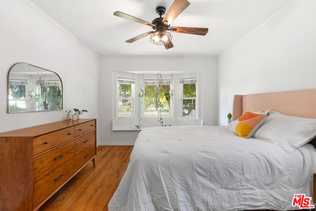 5752 Vesper Avenue Van Nuys, CA 91411 - Photo 7 of 30 a bedroom with a bed and a chandelier