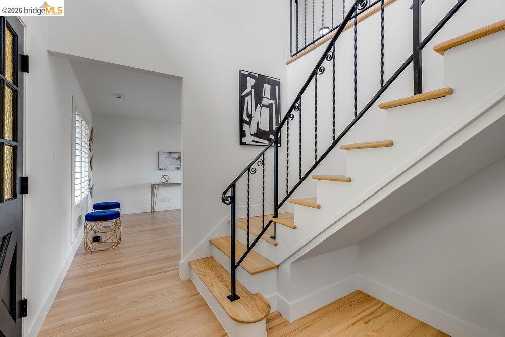 1298 Ribbon Street Foster City, CA 94404 - Photo 16 of 86 Hardwood flooring and a staircase with an ornamental wrought iron railing define this entryway