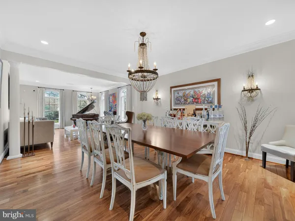 a view of a dining room and livingroom with furniture wooden floor and a rug