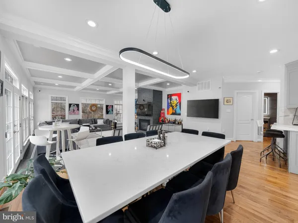 a living room with furniture a flat screen tv and kitchen view