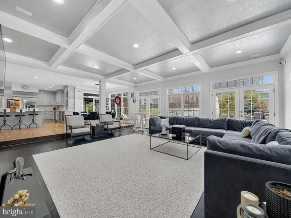 a living room with furniture a flat screen tv and a large window