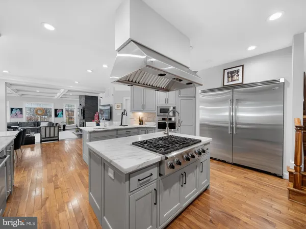 a spacious bedroom with a bed and a painting on the wall