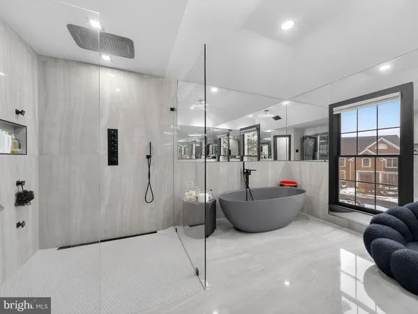 a bedroom with a large bed and wooden floor