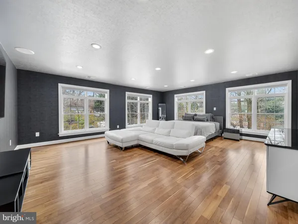 a front view of a building with trees