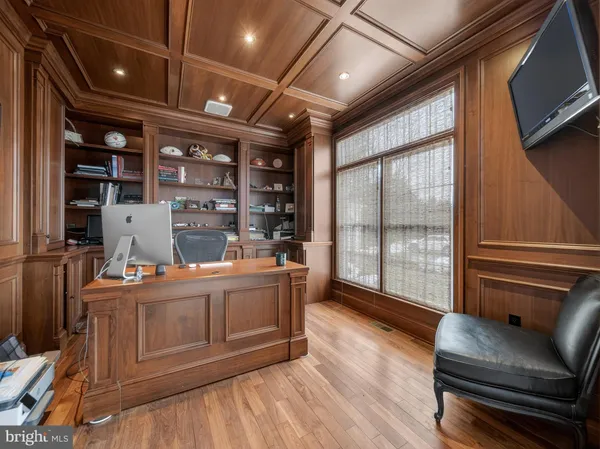 a living room with furniture appliances and a large window