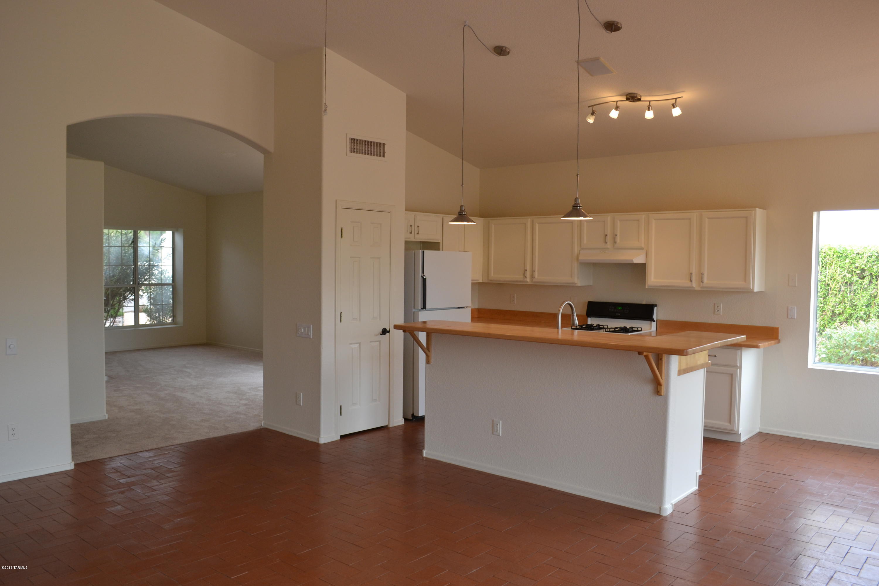 5640 North Cherokee Ridge Road Tucson, AZ 85750 - Photo 6 of 39 a kitchen with stainless steel appliances a sink stove and cabinets