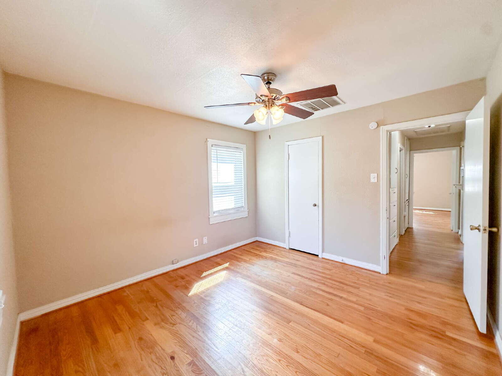 3714 26th Street Lubbock, TX 79410 - Photo 14 of 18 wooden floor in an empty room with a window