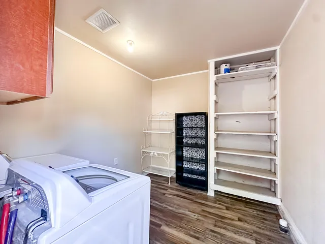 a view of walk in closet with empty racks
