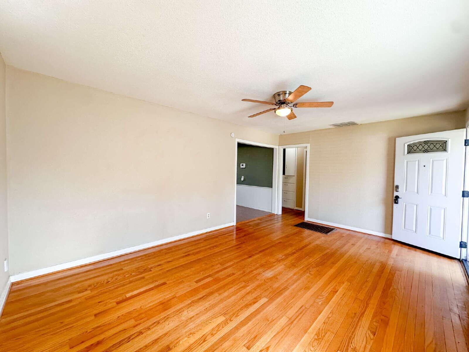 3714 26th Street Lubbock, TX 79410 - Photo 4 of 18 an empty room with wooden floor and ceiling fan